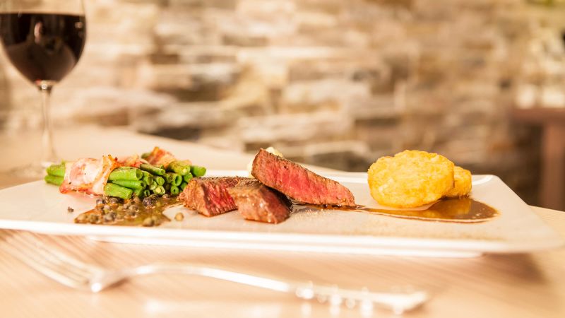 Rumpsteak "Strindberg" mit Zwiebel-Senfkruste, Bohnenbündchen und Röstitaler